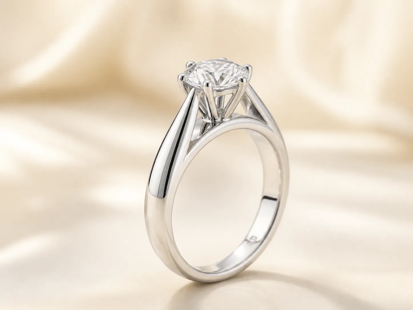 White-gold solitaire engagement ring shown from the side